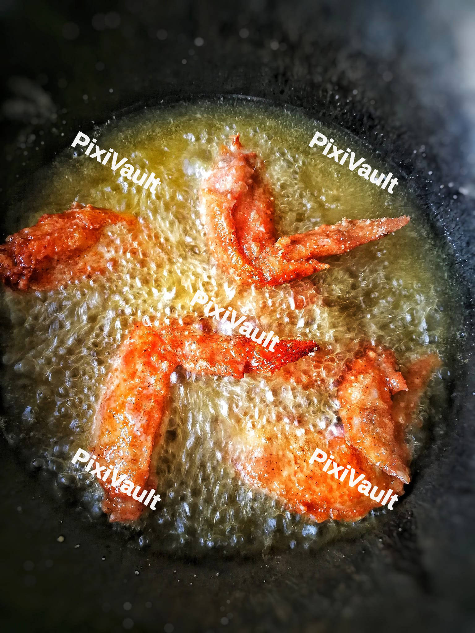 Fried chicken wings in the boiling oil